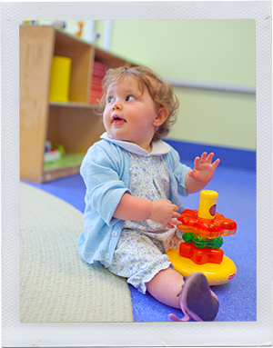 Photograph: An infant girl stacks plastic toy rings. (Photograph by Alex Lazara)
