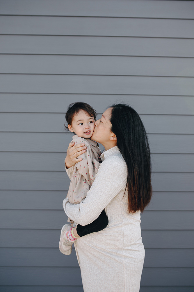 Photograph: A pregnant woman holds a toddler against her belly, kissing them on the cheek. (Pexels, PNW Production)